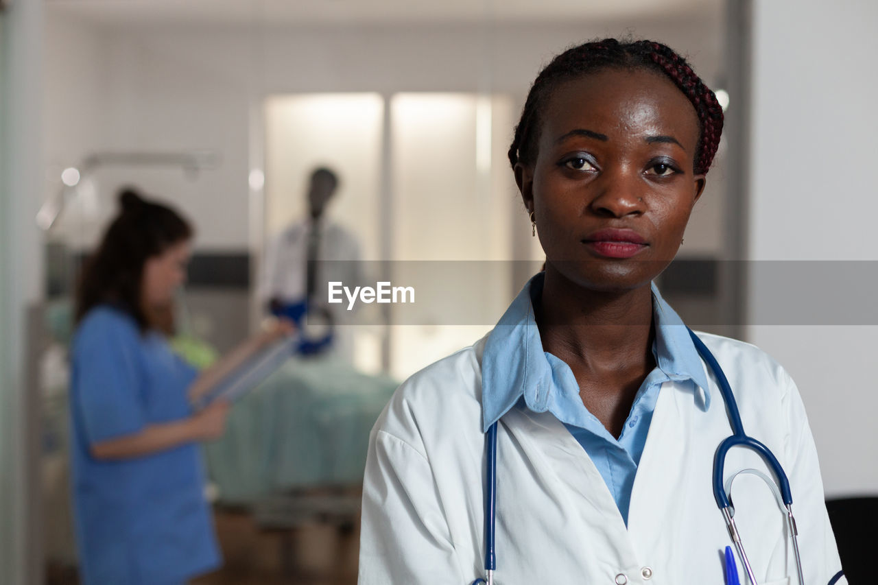 portrait of smiling female doctor standing in clinic