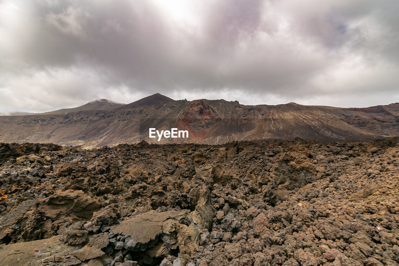 Scenic view of volcanic mountain against sky