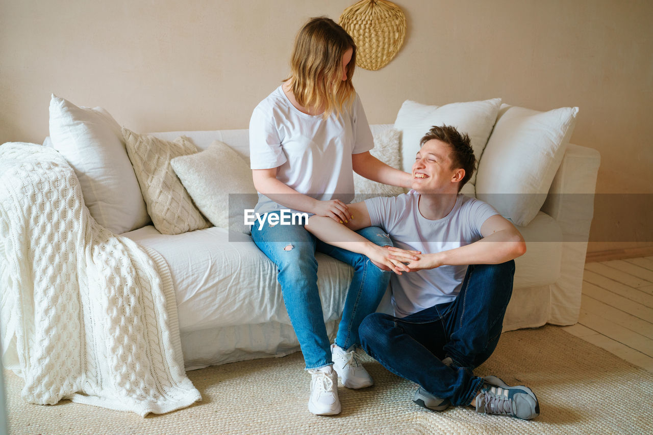 Portrait of an emotional young couple hugging each other, guy and girl hugging