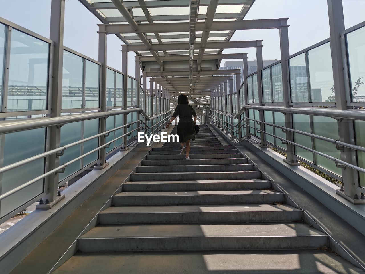 Rear view of woman walking on staircase