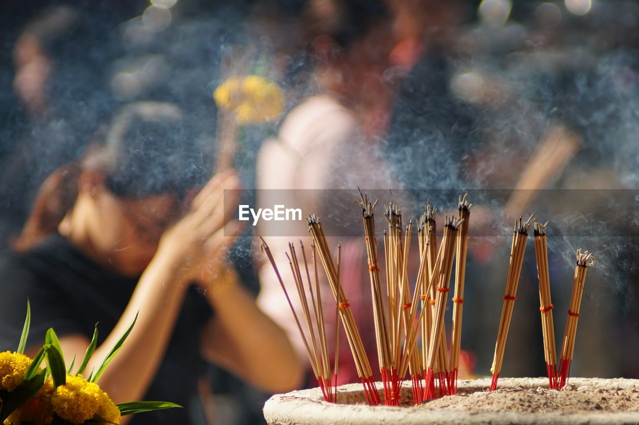 Close-up of lit candles in temple