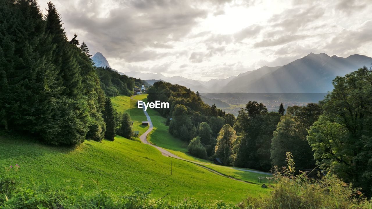 Scenic view of trees and mountains against sky