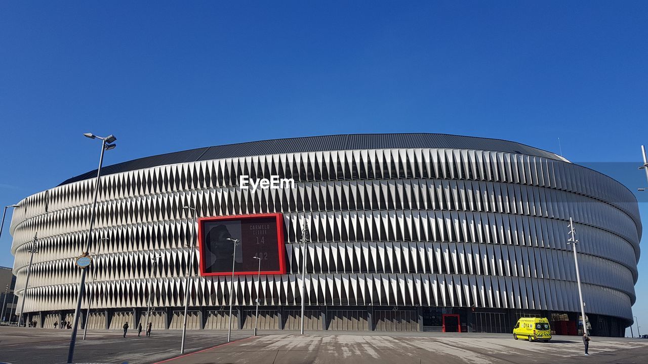 MODERN OFFICE BUILDING AGAINST CLEAR BLUE SKY