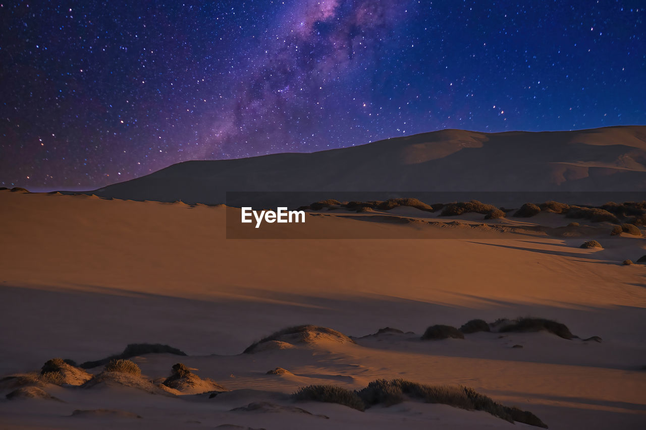 SCENIC VIEW OF MOUNTAINS AGAINST SKY AT NIGHT