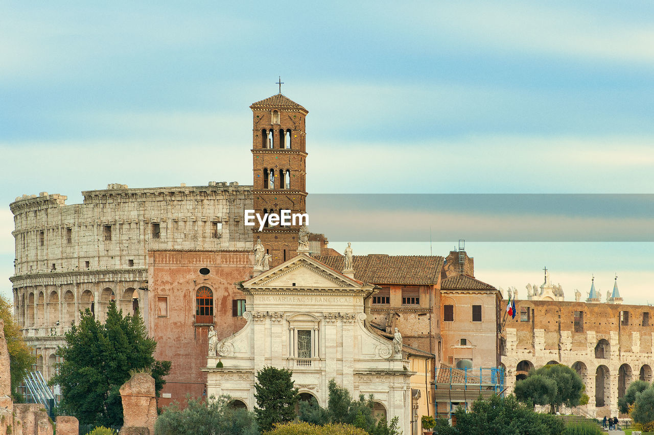 architecture, built structure, building exterior, history, the past, sky, travel destinations, building, nature, landmark, town, travel, city, tree, historic site, tourism, plant, château, cloud, old, no people, tower, religion, place of worship, day, cityscape, outdoors, palace, castle, ancient, ancient history, belief