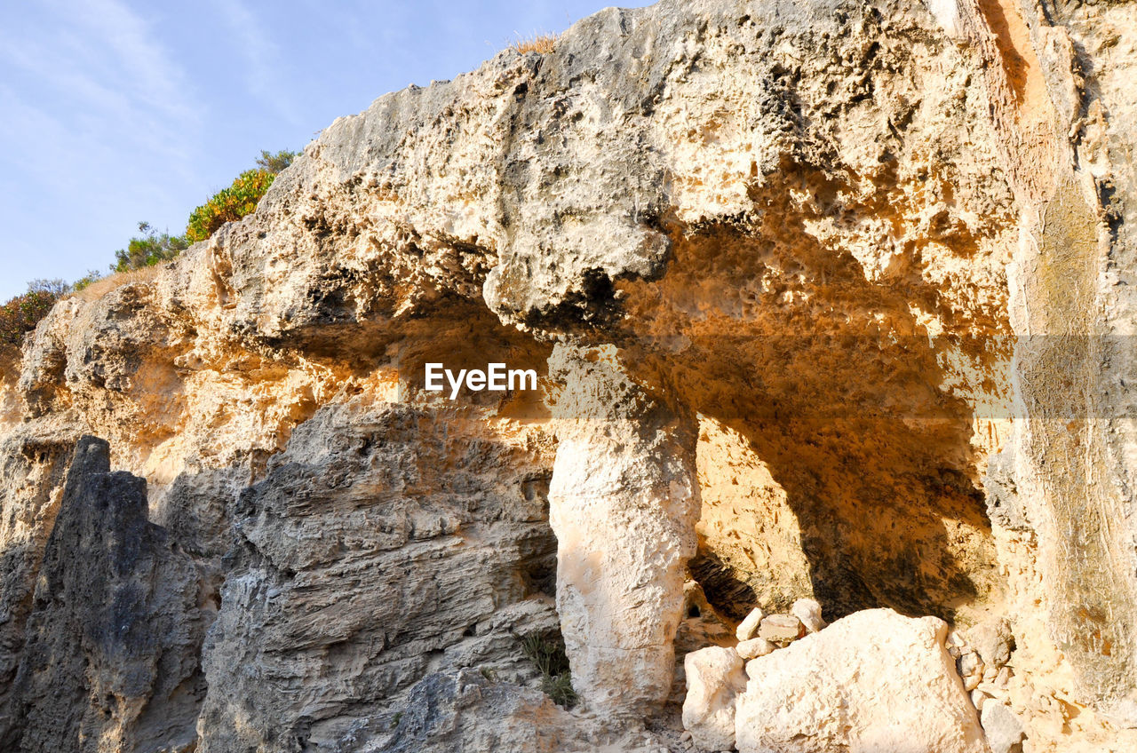 Close-up of rock formation against sky