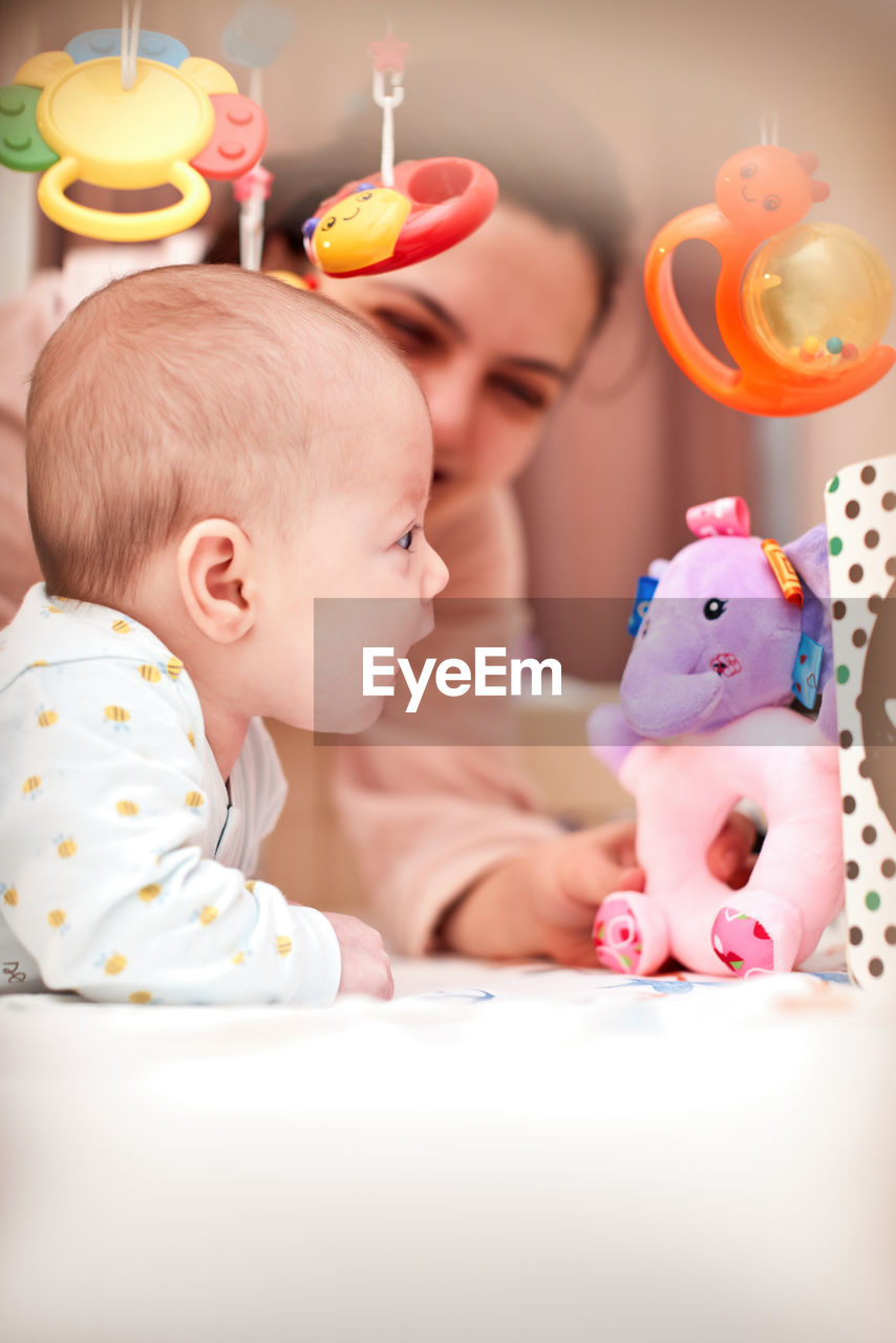 portrait of cute baby girl sitting on sofa