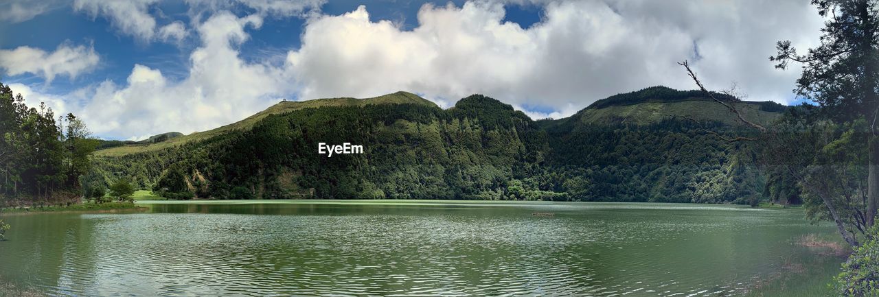 PANORAMIC VIEW OF LAKE BY TREES AGAINST SKY