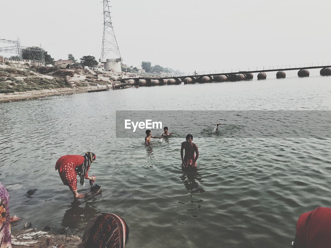 PEOPLE ON SHORE AGAINST CLEAR SKY