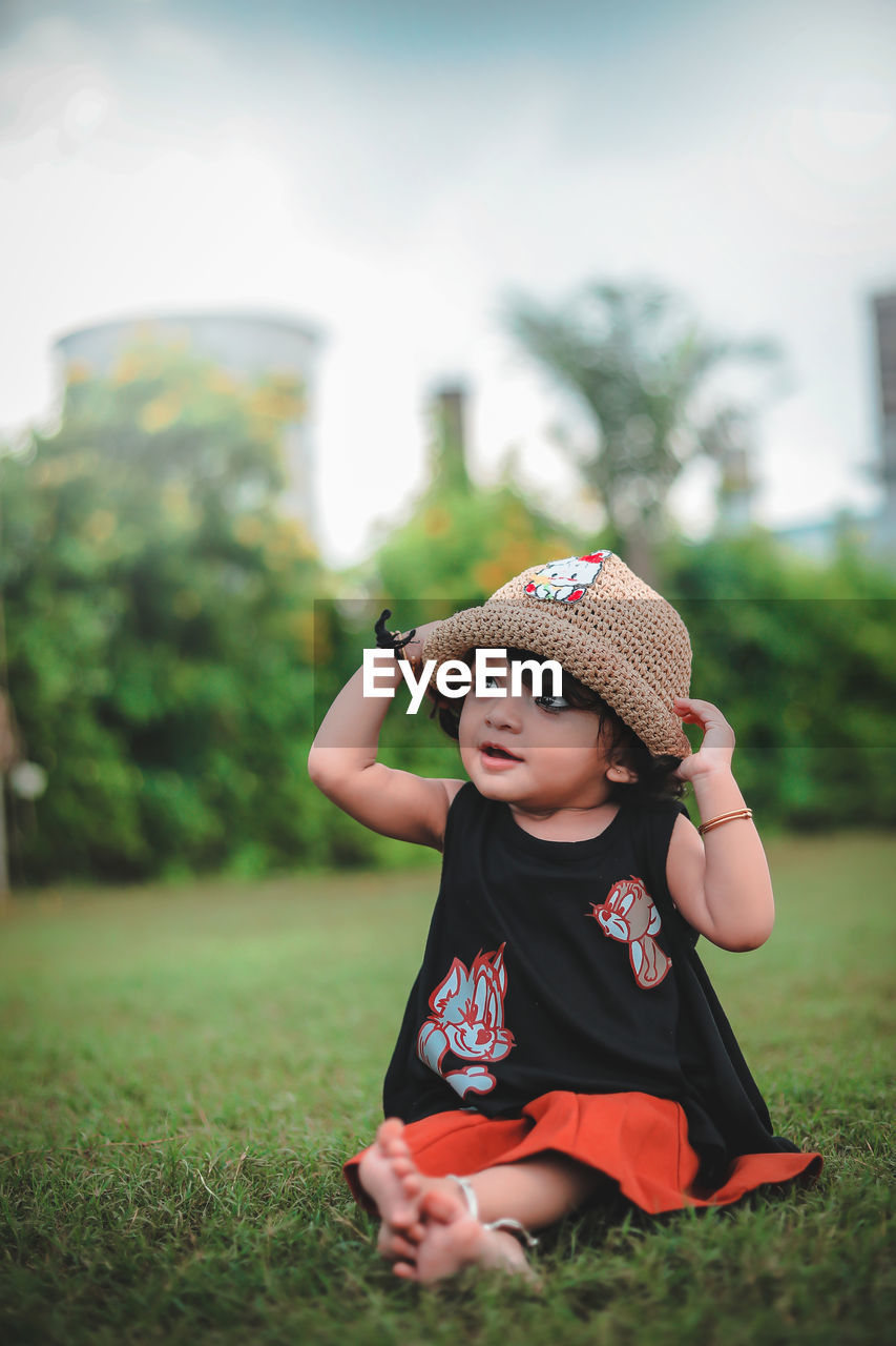 CUTE GIRL IN HAT ON FIELD