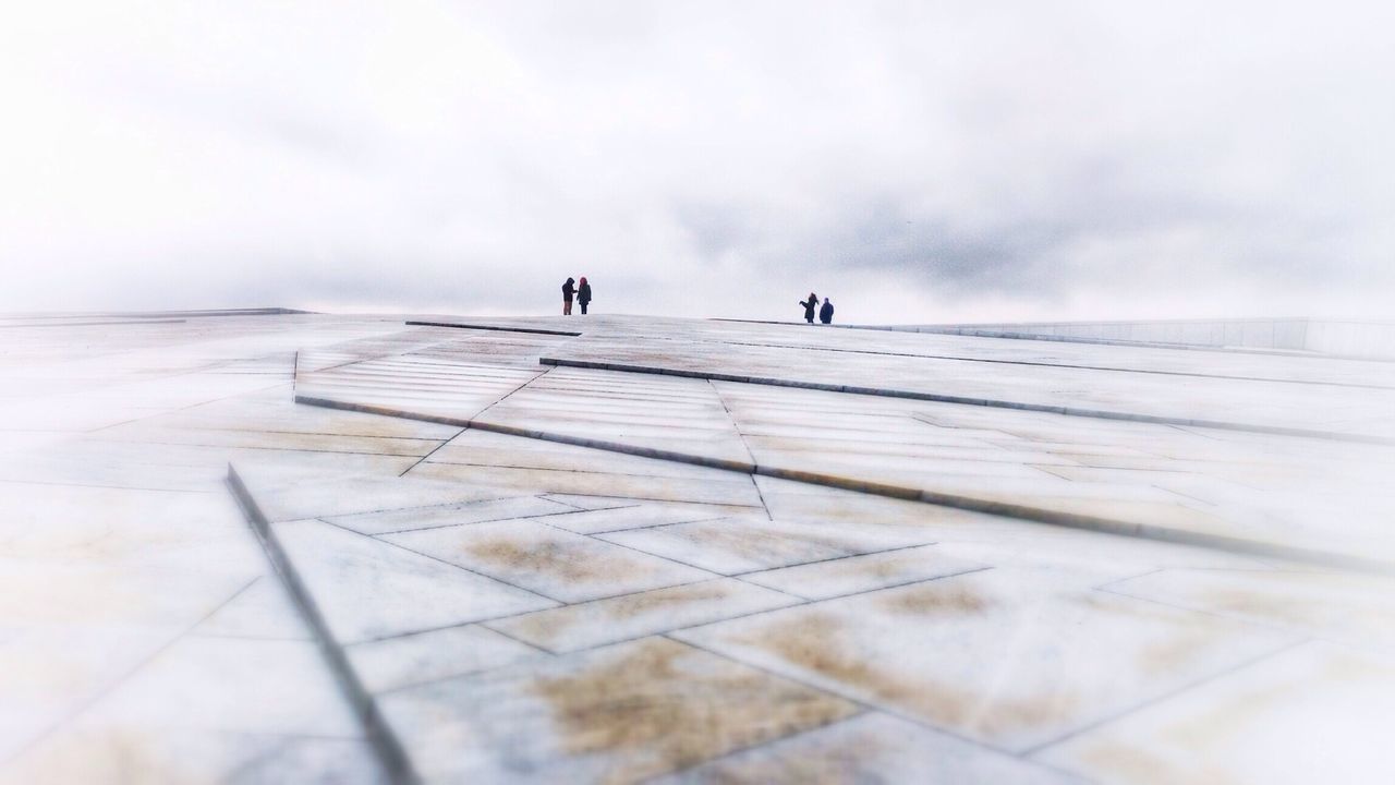 Distance shot of people at oslo opera house