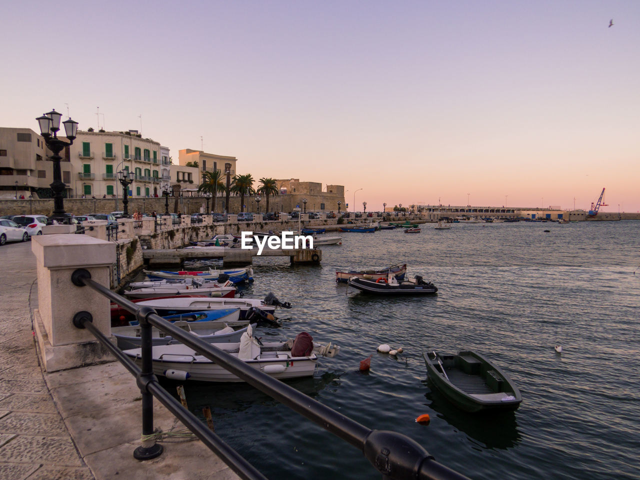 BOATS MOORED IN MARINA AT SUNSET