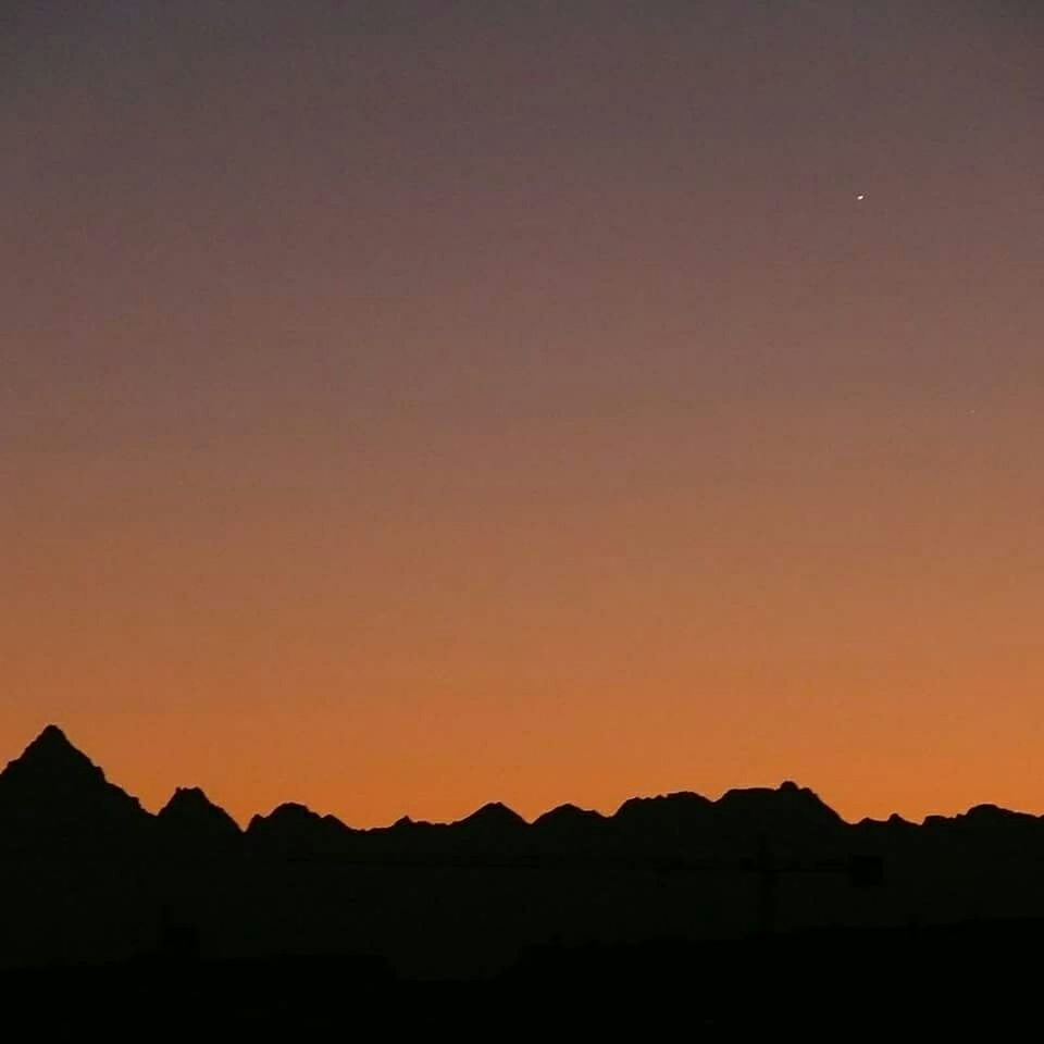 SCENIC VIEW OF MOUNTAINS AT SUNSET