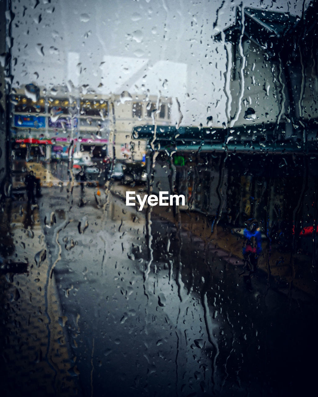 RAINDROPS ON GLASS WINDOW OF RAINY SEASON