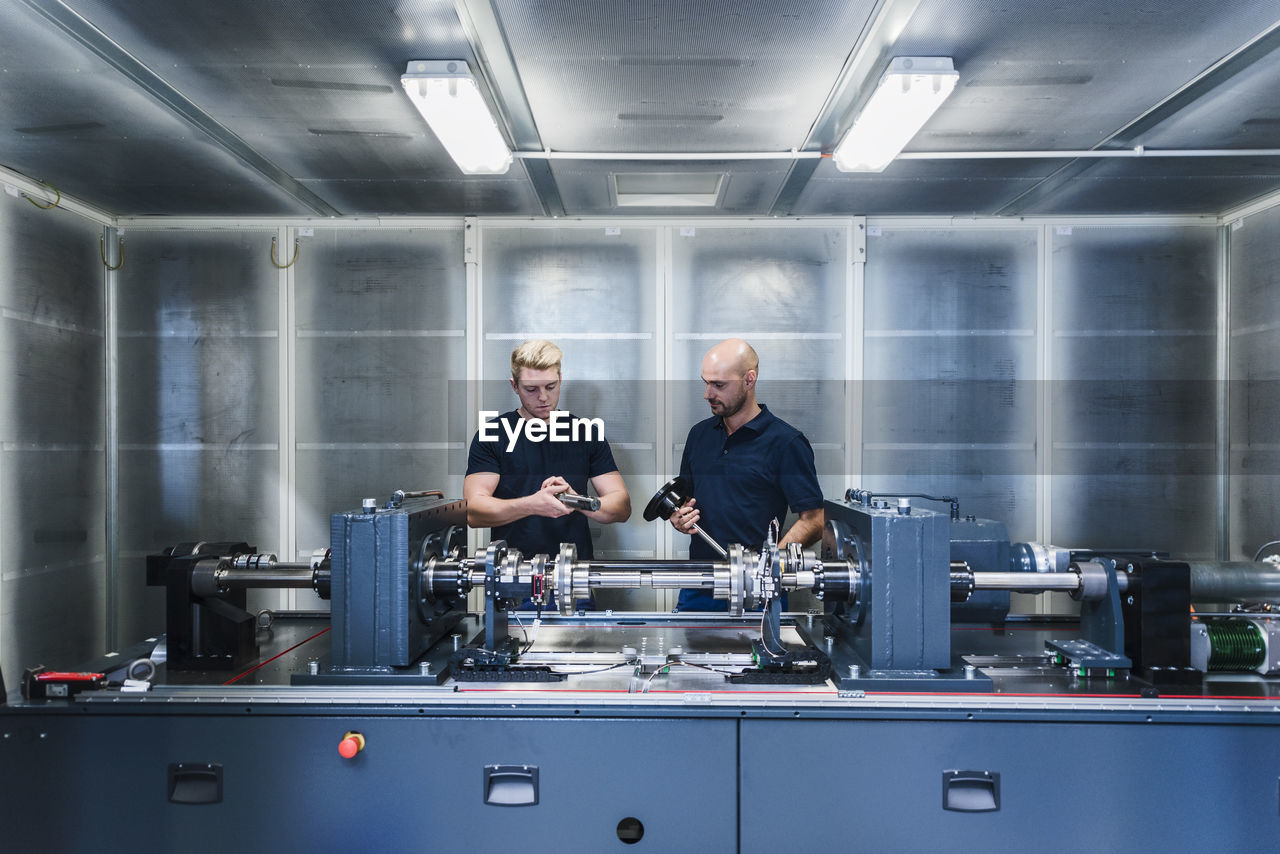 Two colleagues working in modern factory