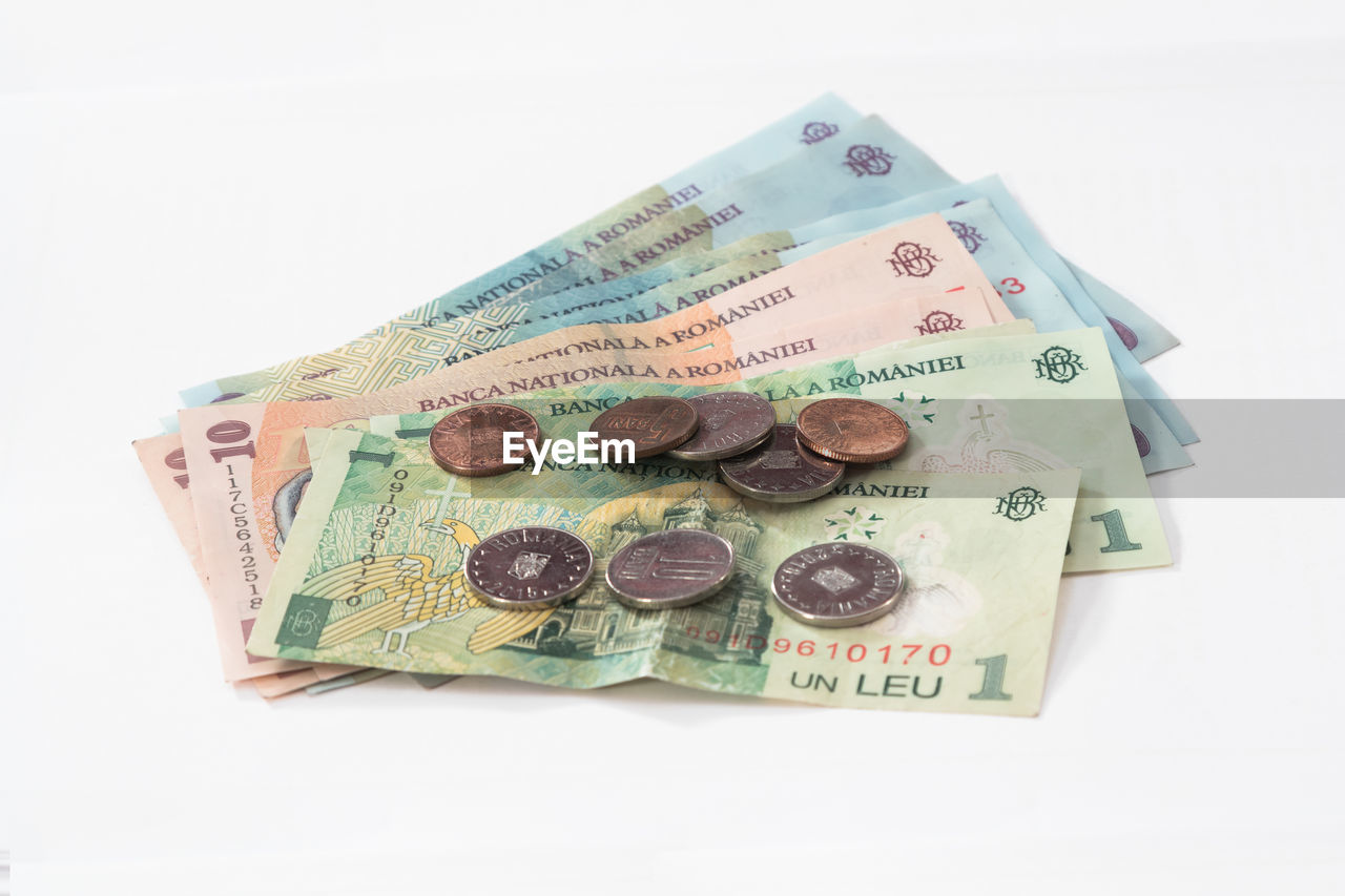 Close-up of various paper currency on white background