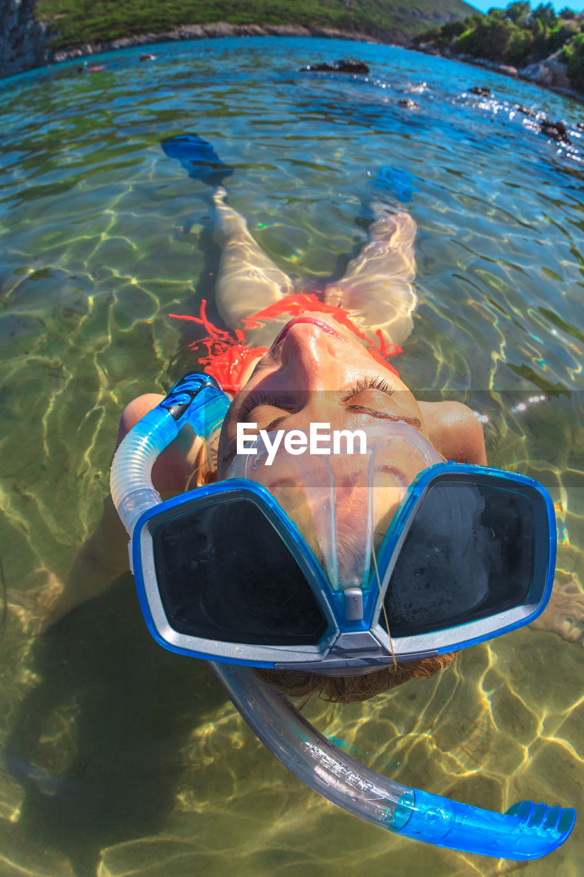 High angle view of woman snorkeling in sea