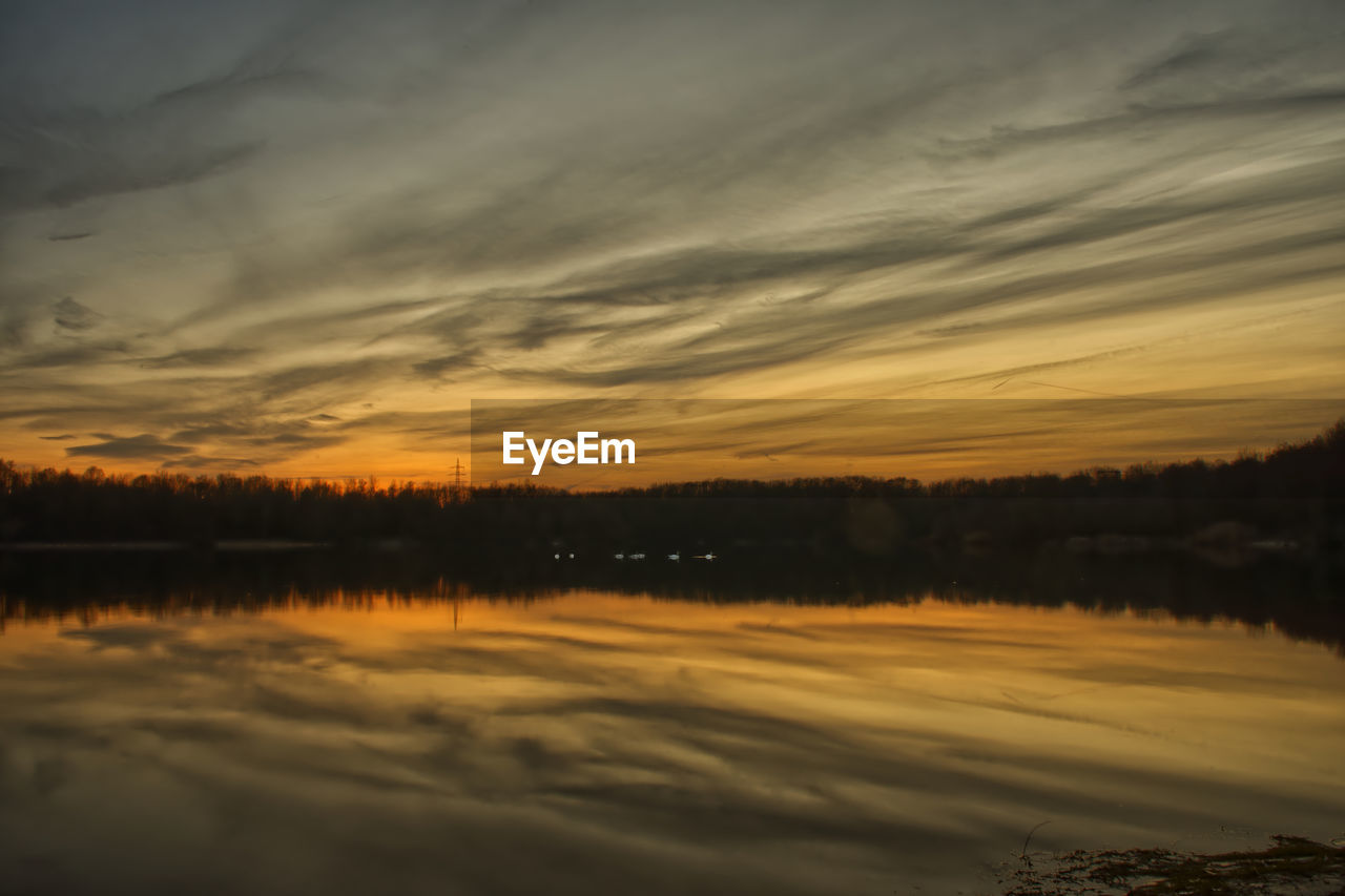 Scenic view of lake against sky during sunset