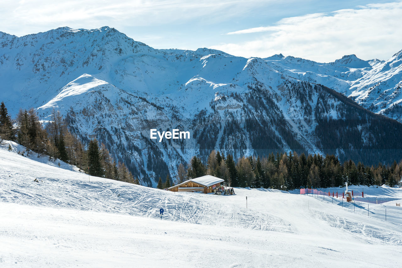 Scenic view of snow covered mountains against sky