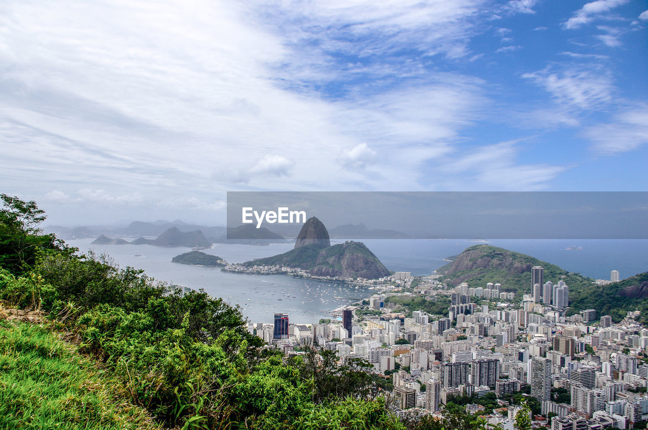 View of cityscape against cloudy sky