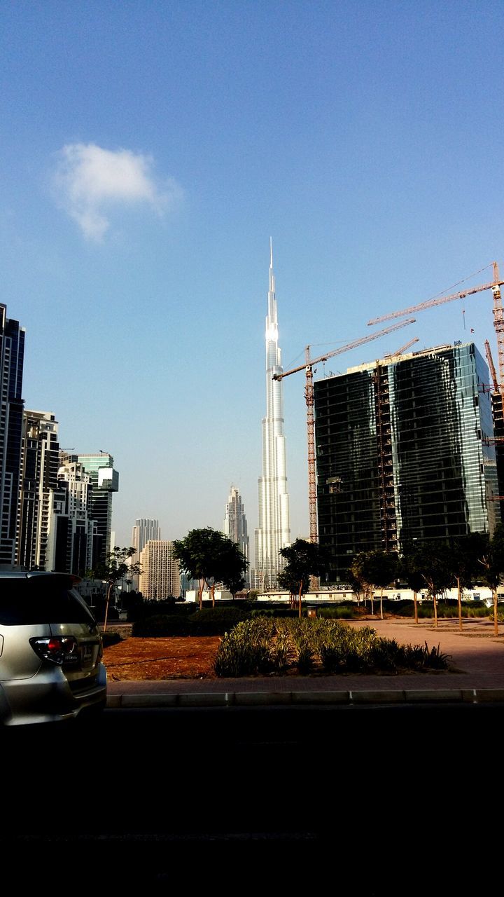 MODERN BUILDINGS IN CITY AGAINST BLUE SKY