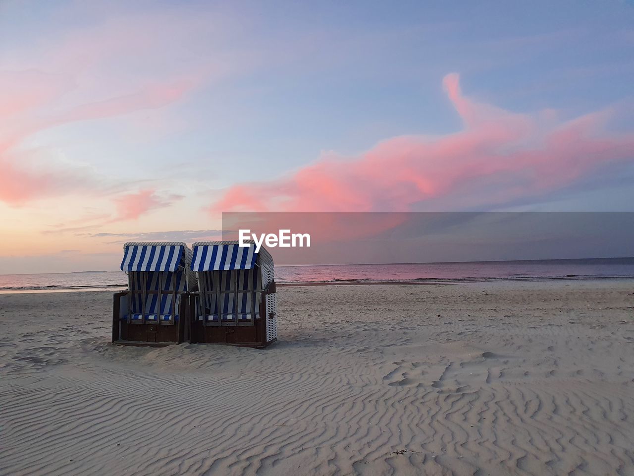 Scenic view of beach against sky during sunset