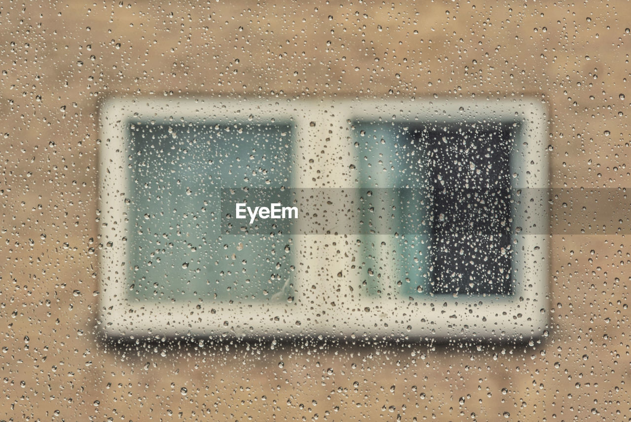 Full frame shot of wet window in rainy season