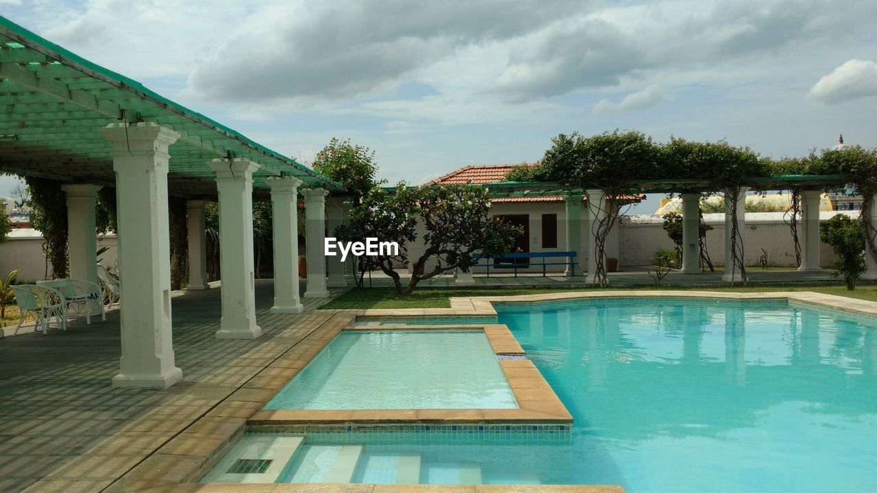 VIEW OF SWIMMING POOL IN FRONT OF BUILDINGS