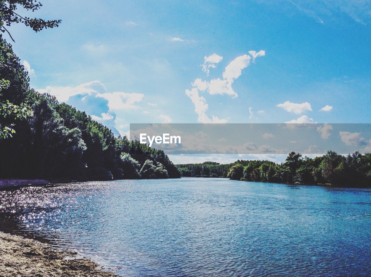 LAKE BY TREES AGAINST SKY