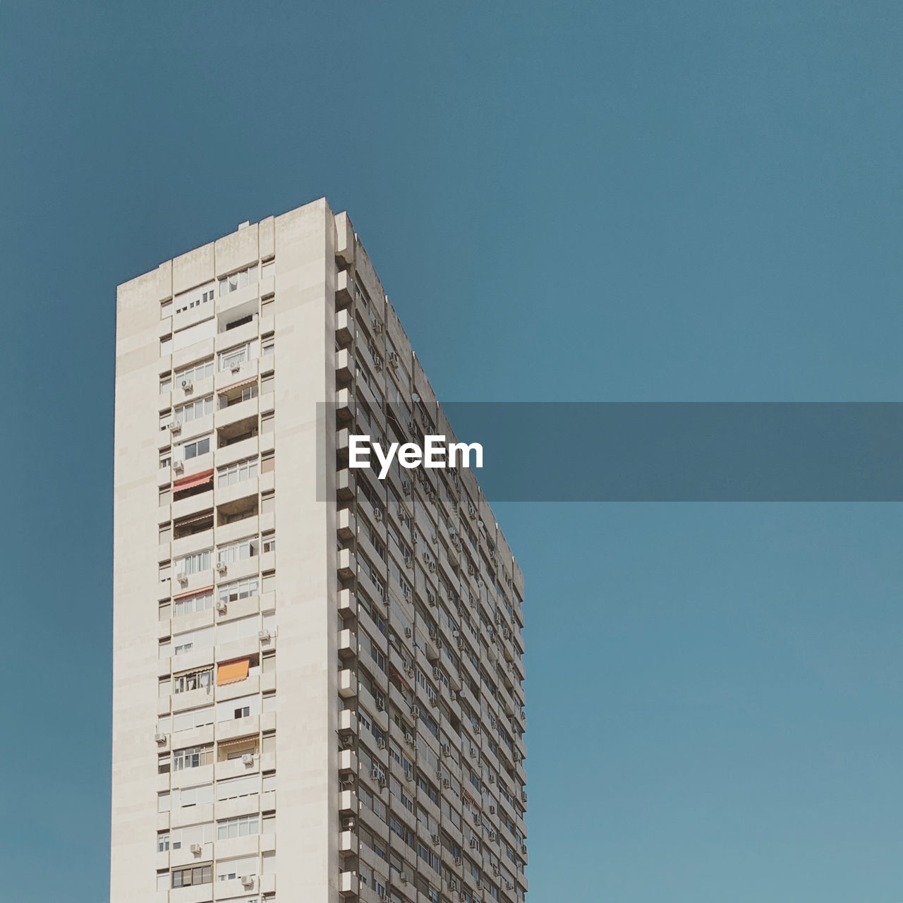 Low angle view of building against clear blue sky