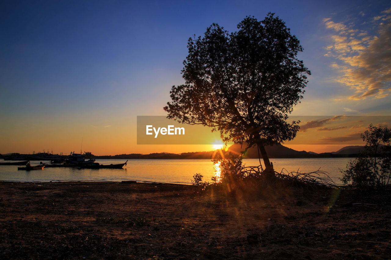 scenic view of lake against sky during sunset