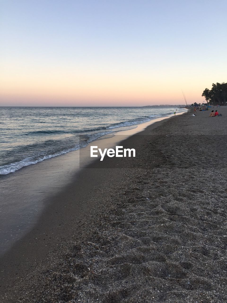 SCENIC VIEW OF BEACH AGAINST SKY DURING SUNSET