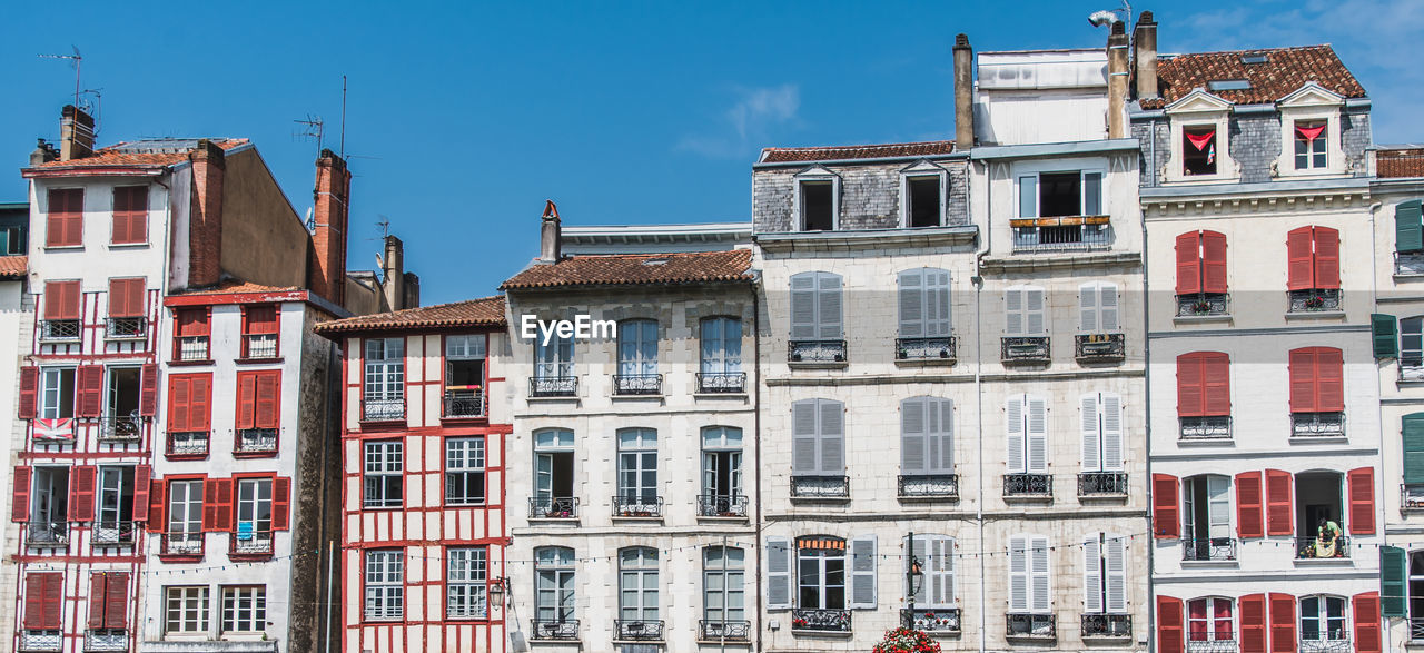 LOW ANGLE VIEW OF RESIDENTIAL BUILDINGS IN TOWN