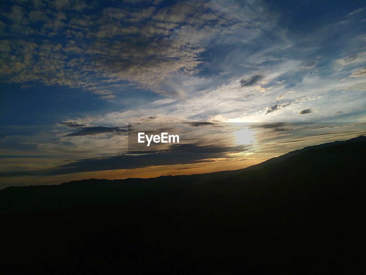 SCENIC VIEW OF SILHOUETTE LANDSCAPE AGAINST SUNSET SKY