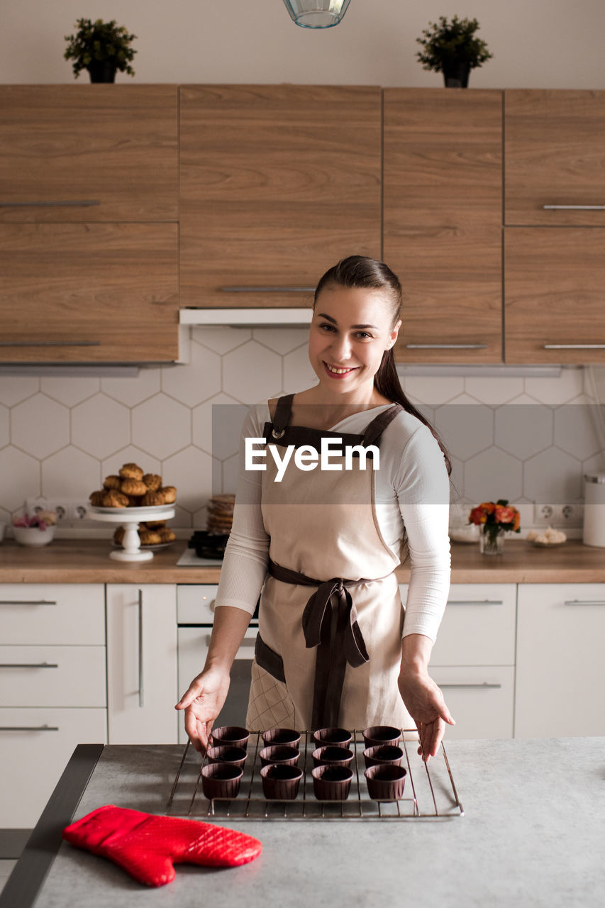 Portrait of chef preparing batter in kitchen