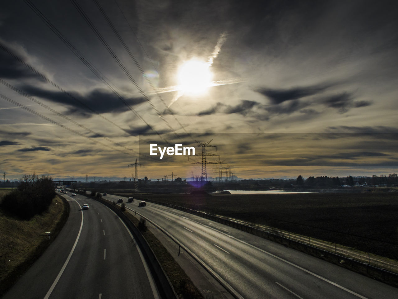 VIEW OF ROAD AGAINST SKY AT SUNSET