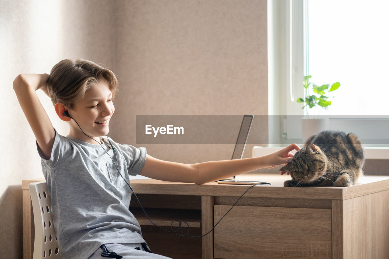 side view of boy looking at daughter while sitting at home