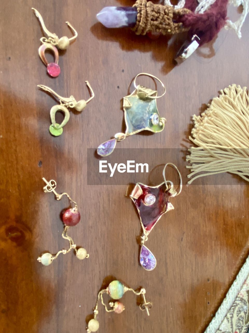 wood, indoors, food and drink, high angle view, food, table, still life, no people, necklace, jewellery, large group of objects, variation, art, freshness, nature, healthy eating, plant, flower, leaf, directly above, earring, creativity, wellbeing, fashion accessory
