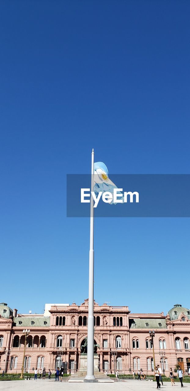 LOW ANGLE VIEW OF FLAGS FLAG AGAINST BLUE SKY