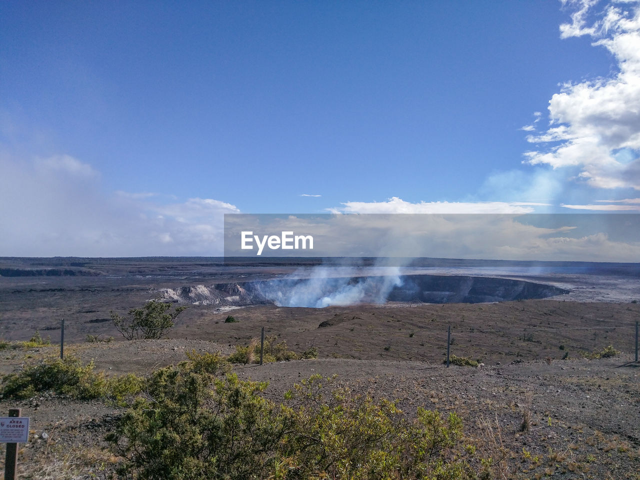 Smoke erupting at kilauea against sky