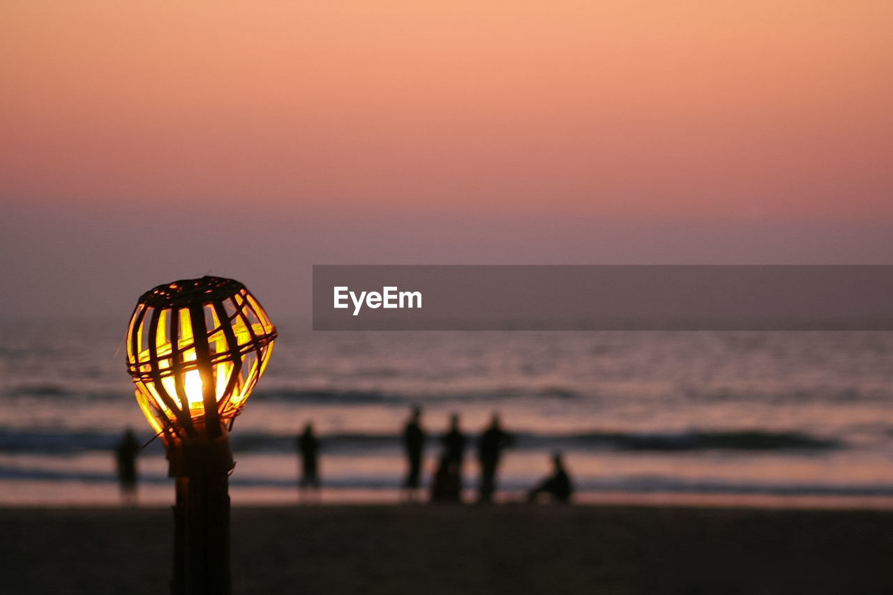 Silhouette of beach against sky during sunset