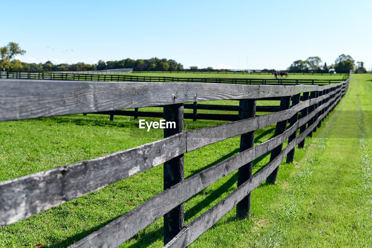 Fence on field against sky