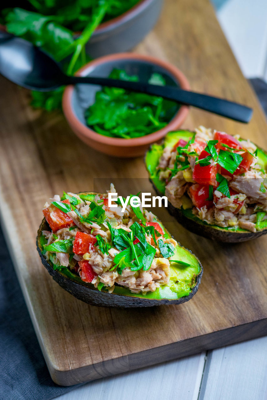 Close-up of stuffed avocado on cutting board