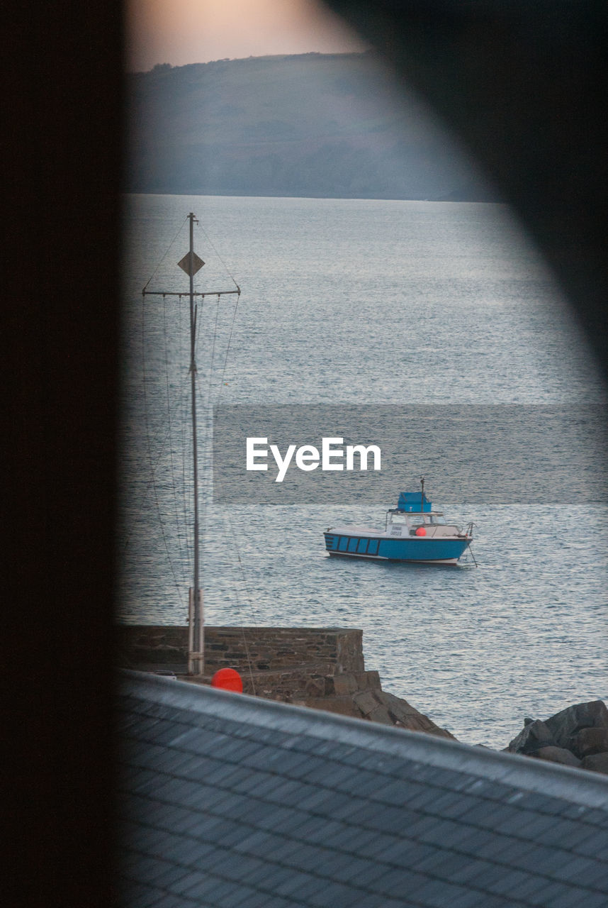 BOAT ON SEA AGAINST SKY