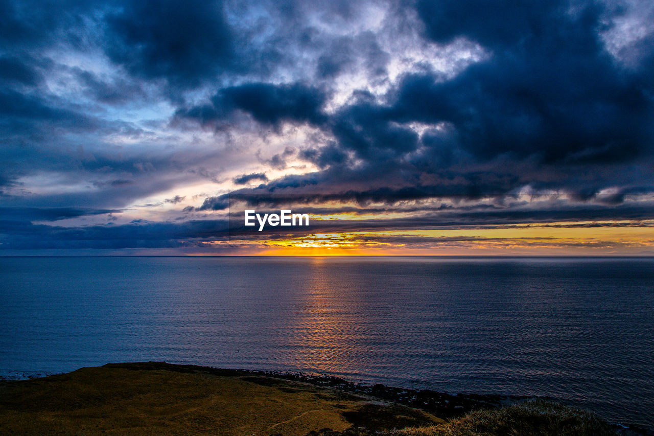 Scenic view of sea against dramatic sky