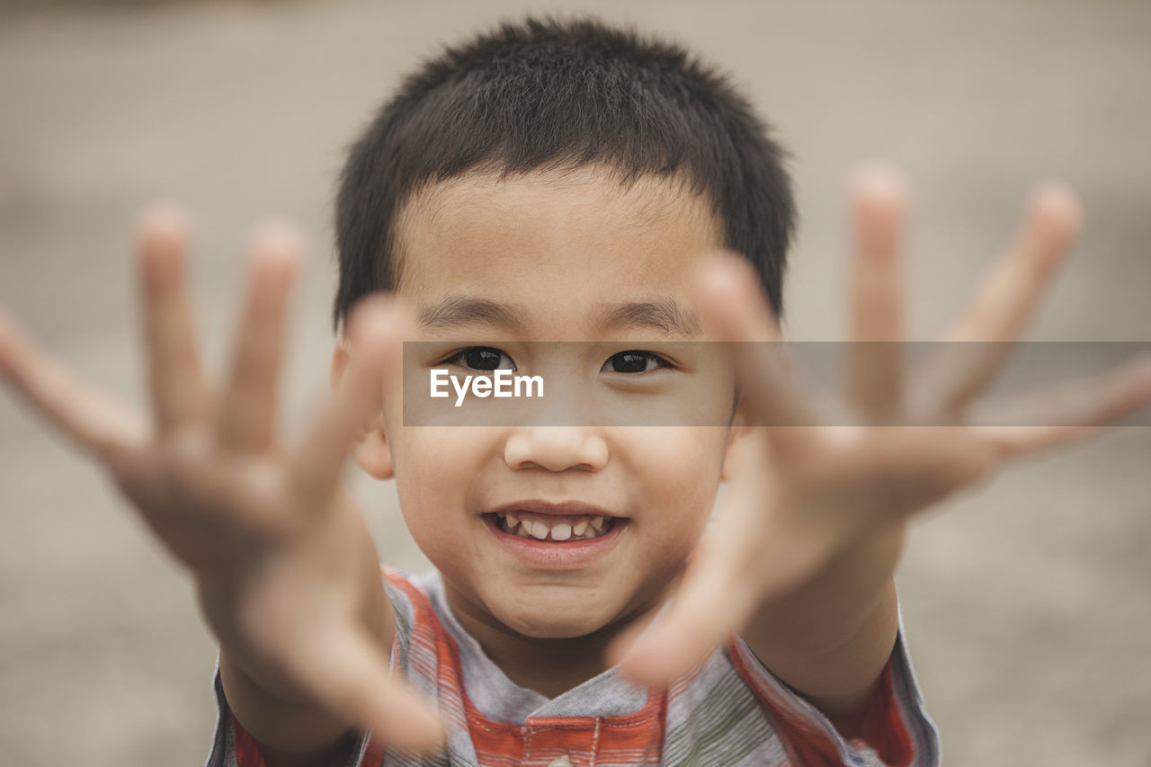 Close-up portrait of innocent boy gesturing