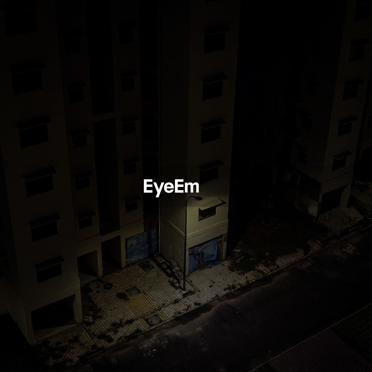 High angle view of street by buildings at night