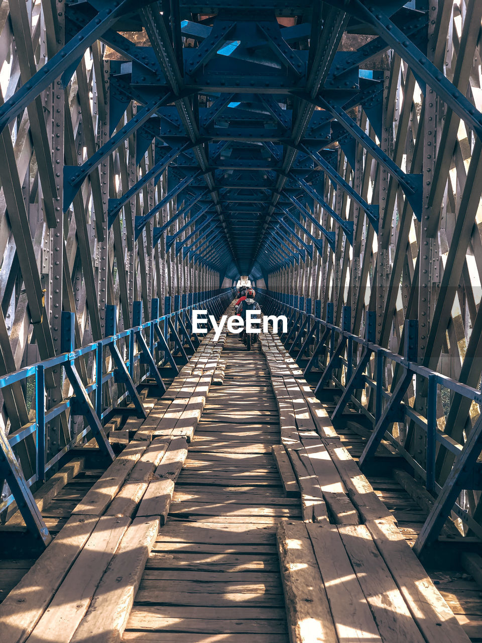 Man walking on footbridge