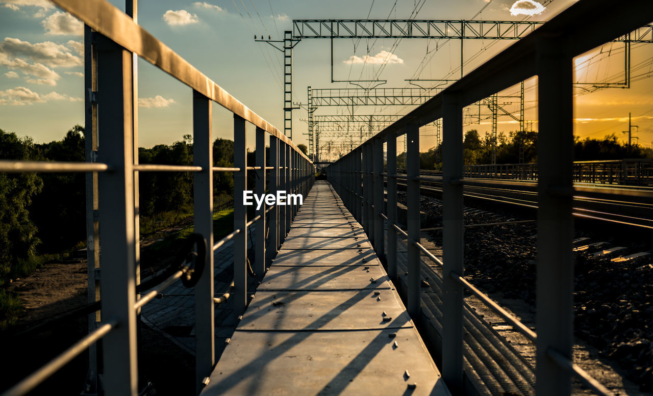 Footbridge against sky in city