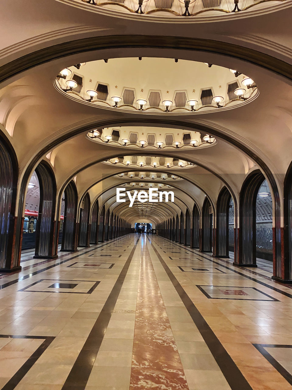 architecture, arch, indoors, metro station, travel, built structure, transportation, rail transportation, travel destinations, public transportation, ceiling, lighting equipment, city, railroad station, flooring, no people, building, mode of transportation, public transport, illuminated, transport, arcade, tourism, diminishing perspective, subway